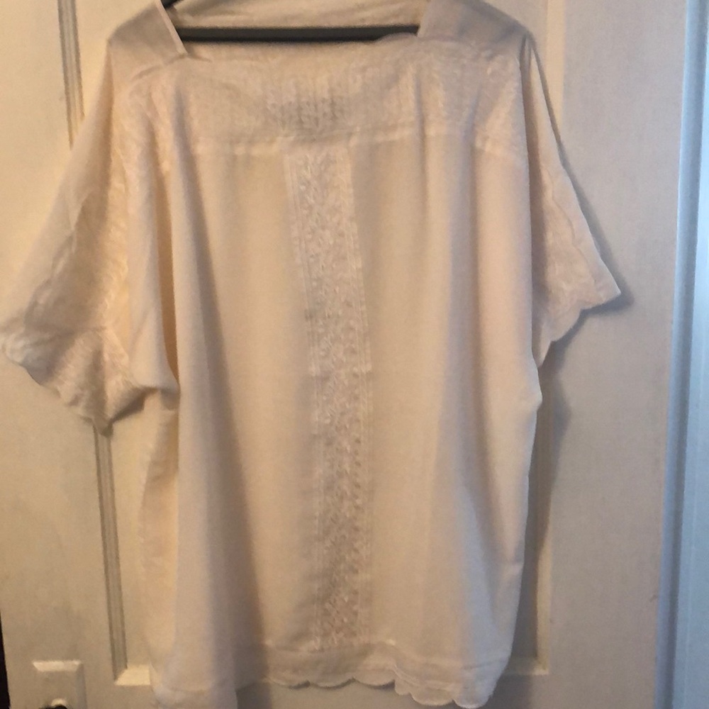 An embroidered cream colored blouse